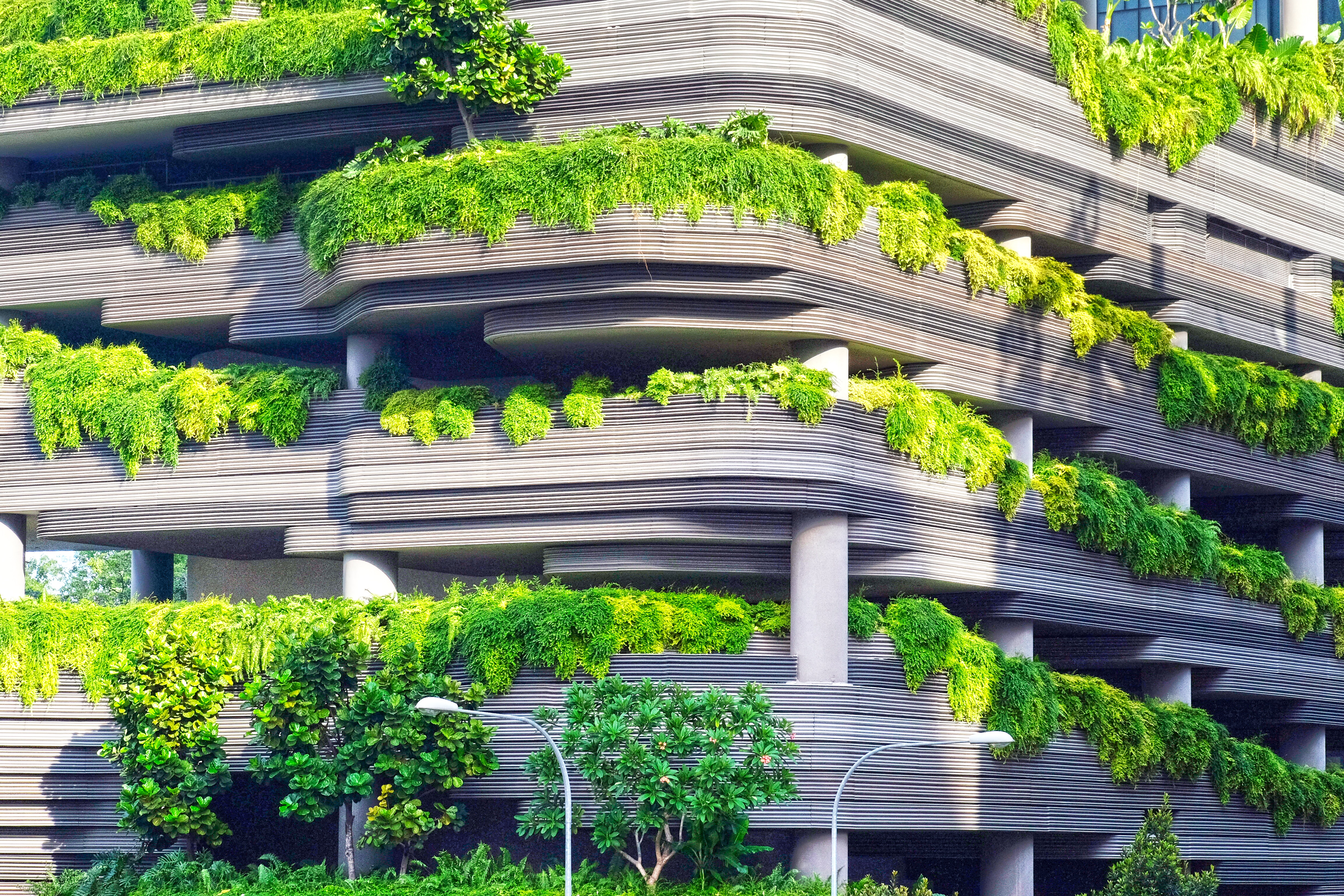 modern parking garage structure overflowing with greenery