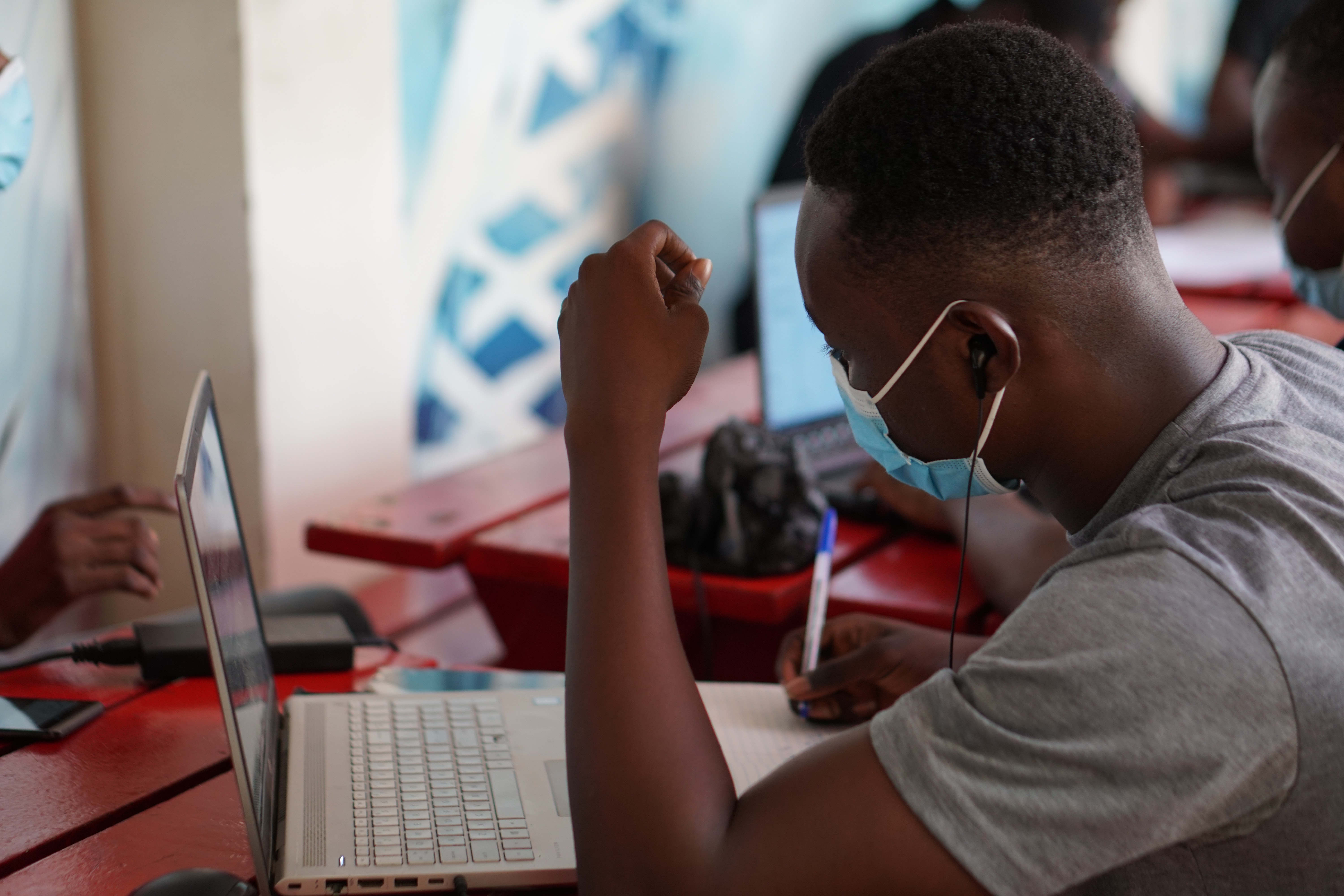Man wearing a mask in an internet cafe in Ghana